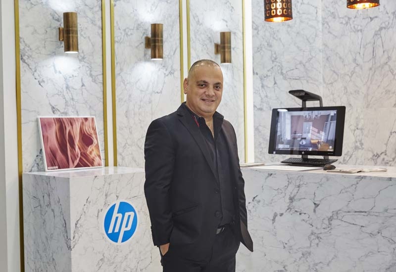 Ernest Azzam stands in front of a facade printed by HP printers. Ernest Azzam stands in front of a facade printed by HP printers.