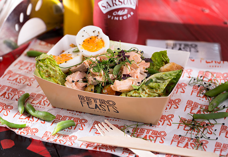 A salmon nicoise salad, served in a casual setting. The brand is meant to be vintage, fun, and playful, and is reflected in how food is served as well. A salmon nicoise salad, served in a casual setting. The brand is meant to be vintage, fun, and playful, and is reflected in how food is served as well.