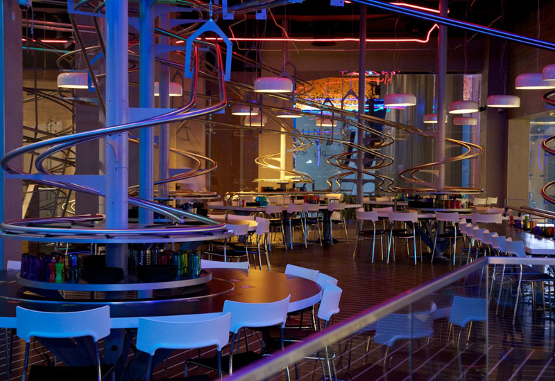 Dishes at Rogo's are delivered to tables via a network of tracks. Dishes at Rogo's are delivered to tables via a network of tracks.