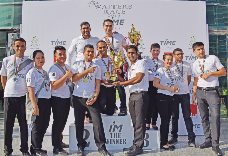 Mahmoud El Rawey retains the TIME Hotels Waiters Race trophy ahead of Okyere Ebenezer and Akbar Ali. Mahmoud El Rawey retains the TIME Hotels Waiters Race trophy ahead of Okyere Ebenezer and Akbar Ali.