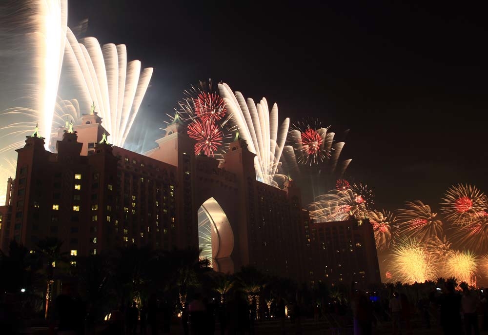 People watch the fireworks on the street outside Atlantis The Palm Dubai. People watch the fireworks on the street outside Atlantis The Palm Dubai.