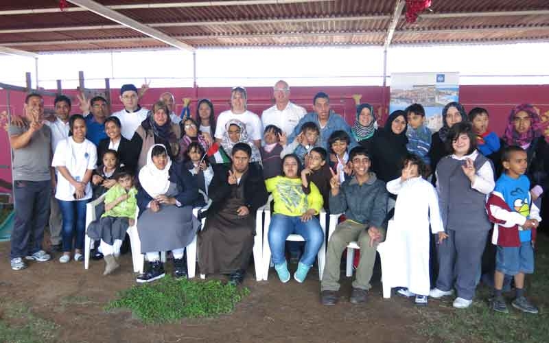 Employees from the Cove Rotana Resort with children from the Specialized Centre for Special Needs. Employees from the Cove Rotana Resort with children from the Specialized Centre for Special Needs.