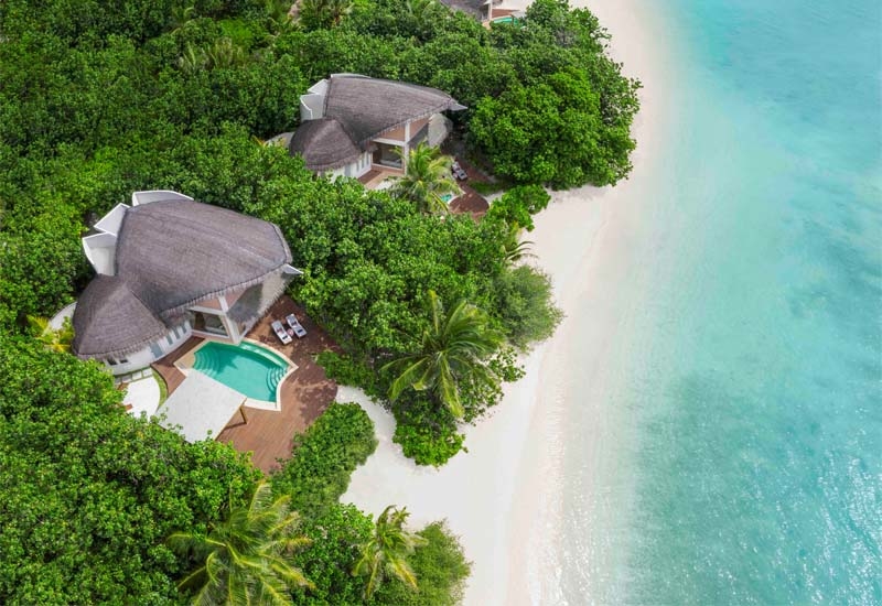 Thatched roofs on villas are reminiscent of inverted dhoni boats, the traditional Maldivian wooden fishing vessels, and slanted roof tips recall white herons dipping their heads into the water Thatched roofs on villas are reminiscent of inverted dhoni boats, the traditional Maldivian wooden fishing vessels, and slanted roof tips recall white herons dipping their heads into the water