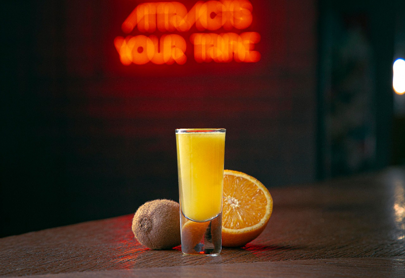 The shot comprises kiwi and orange juice The shot comprises kiwi and orange juice