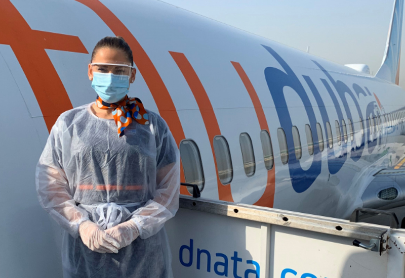 A Flydubai crew member wearing personal protection equipment A Flydubai crew member wearing personal protection equipment